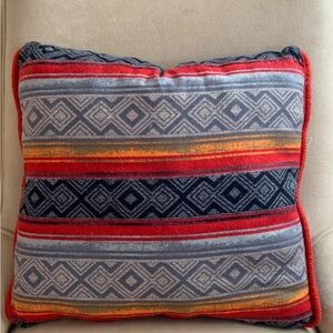 Geometric Patterned Pillow with Red and Blue Accents